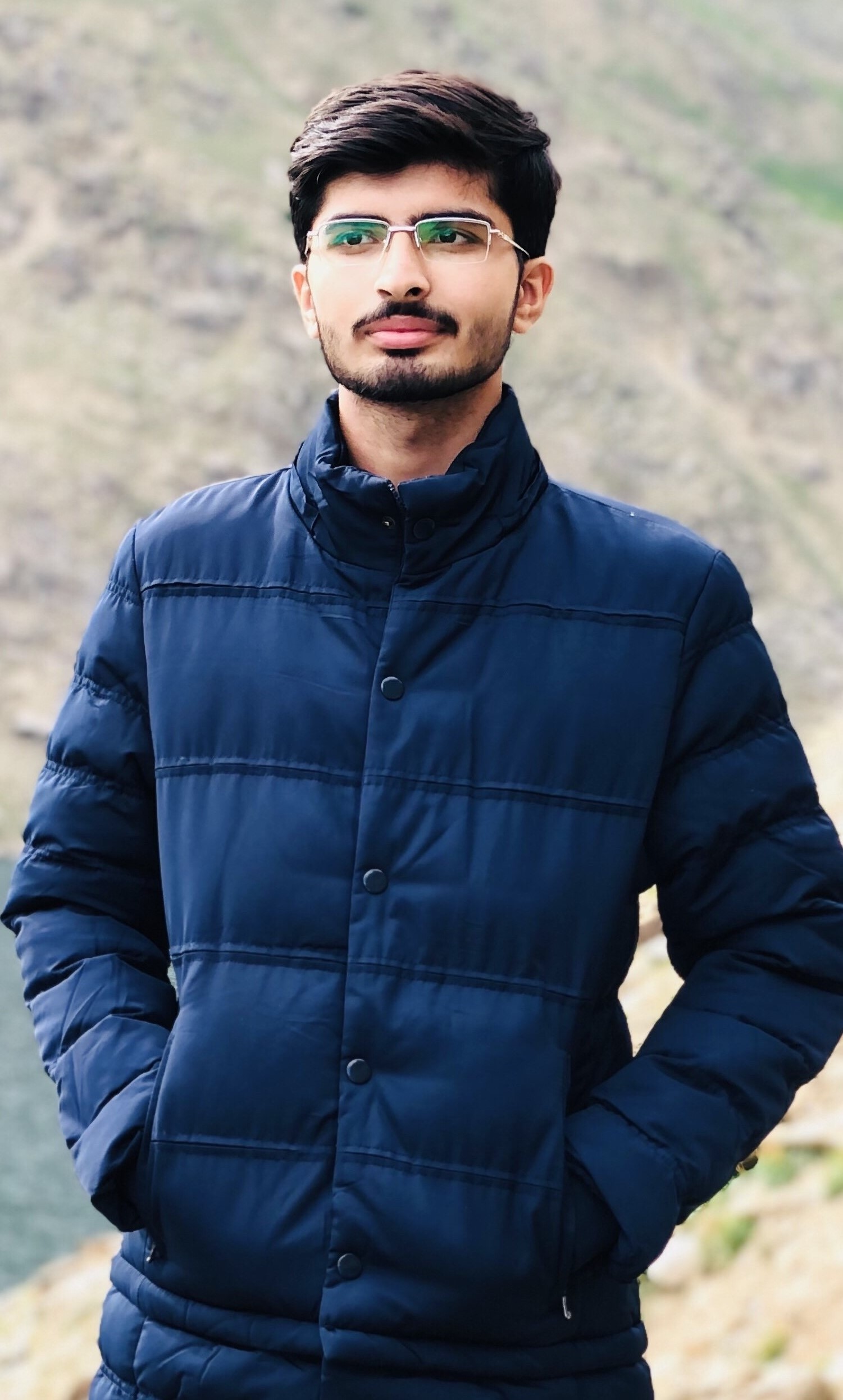Ali Hassan standing with hands in his pockets